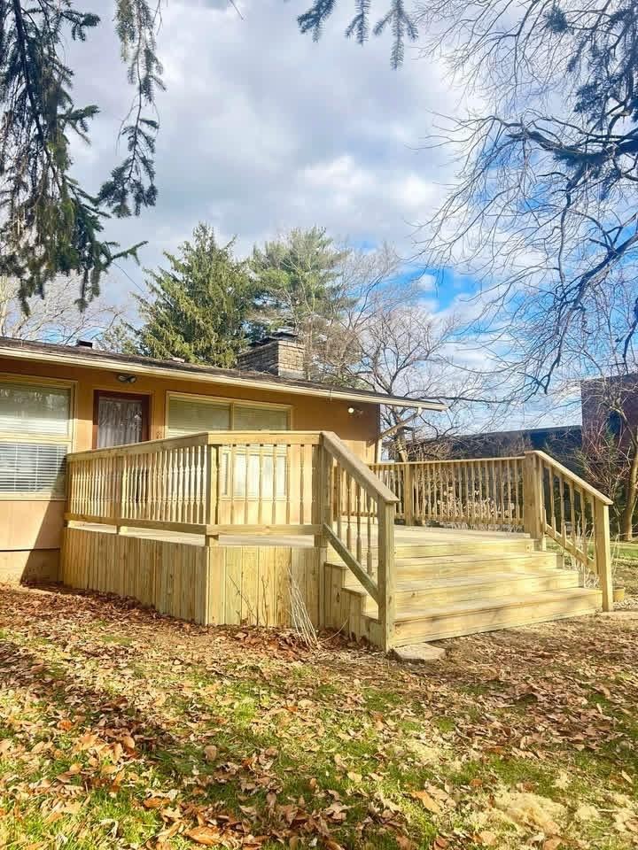 Same deck rebuilt with new boards, skirting, steps, and railings