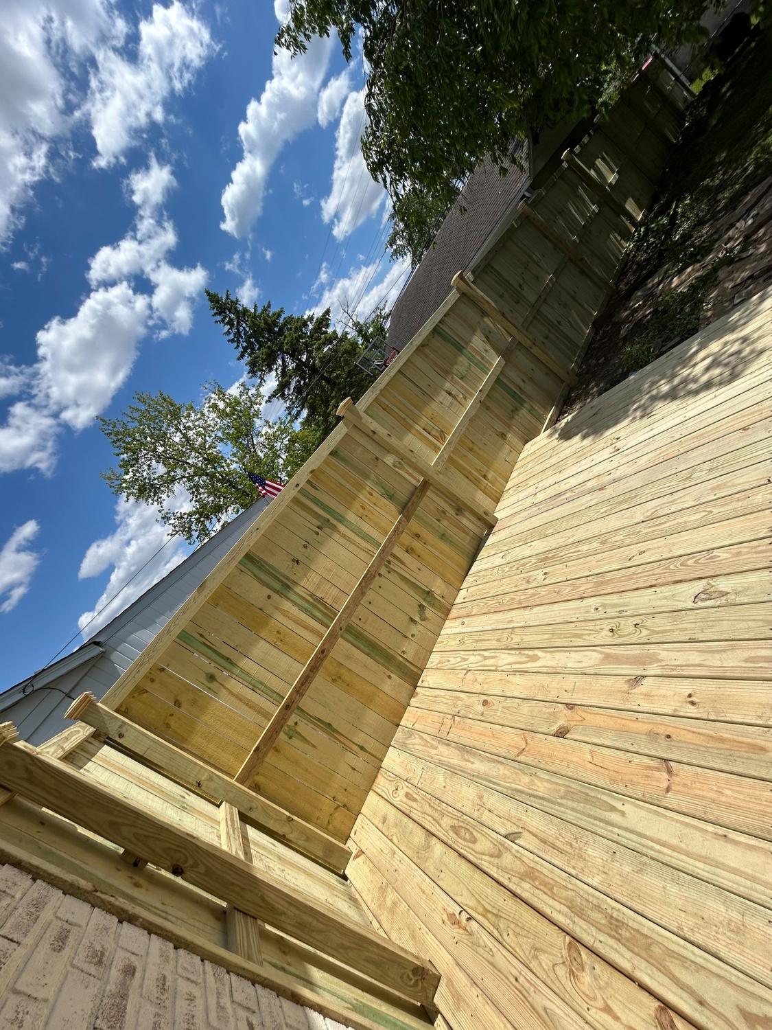 Privacy fence and deck in fresh pressure-treated lumber