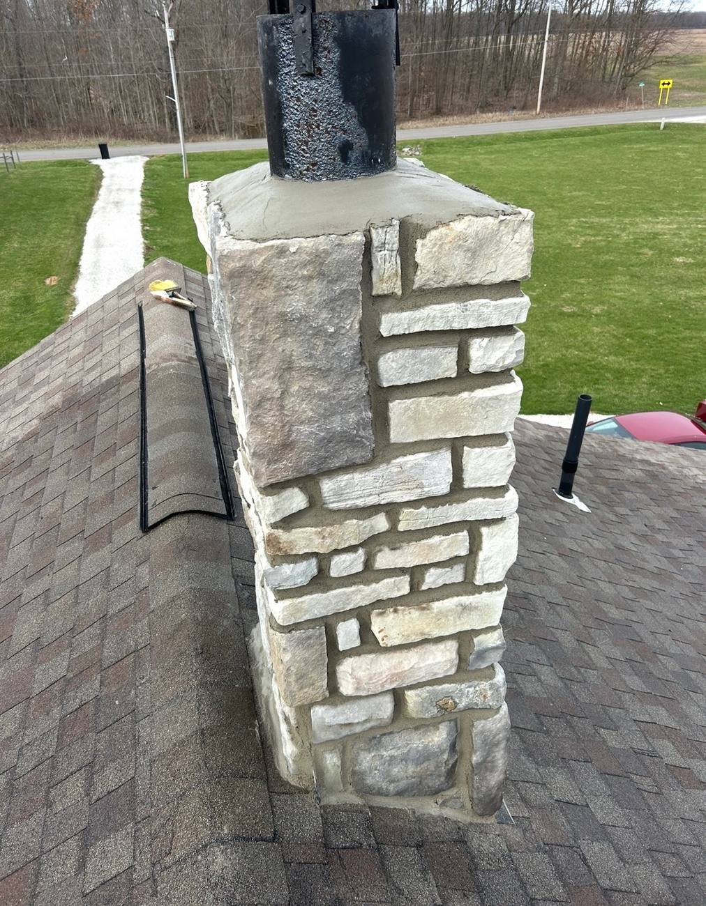 Stone chimney rebuilt with a new mortar crown