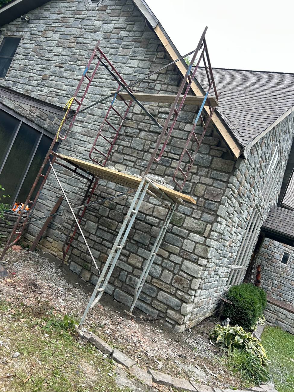 Stone veneer gable wall going up on scaffolding